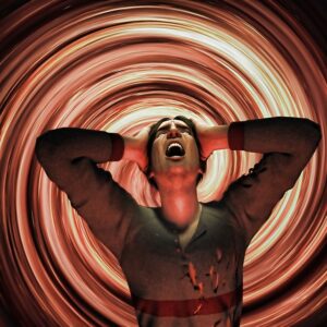 Photo of stressed out man with hands over ears, to show impact misophonia, or extreme sensitivity to sound. Tapping helps reduce the stress and helps regulate emotional reactivity to sensitivity to sound.